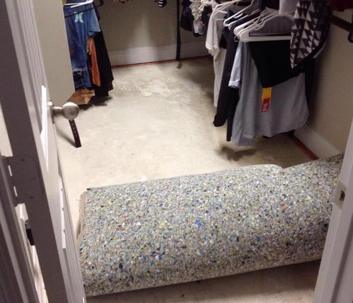 pulled up carpeting in a bedroom closet